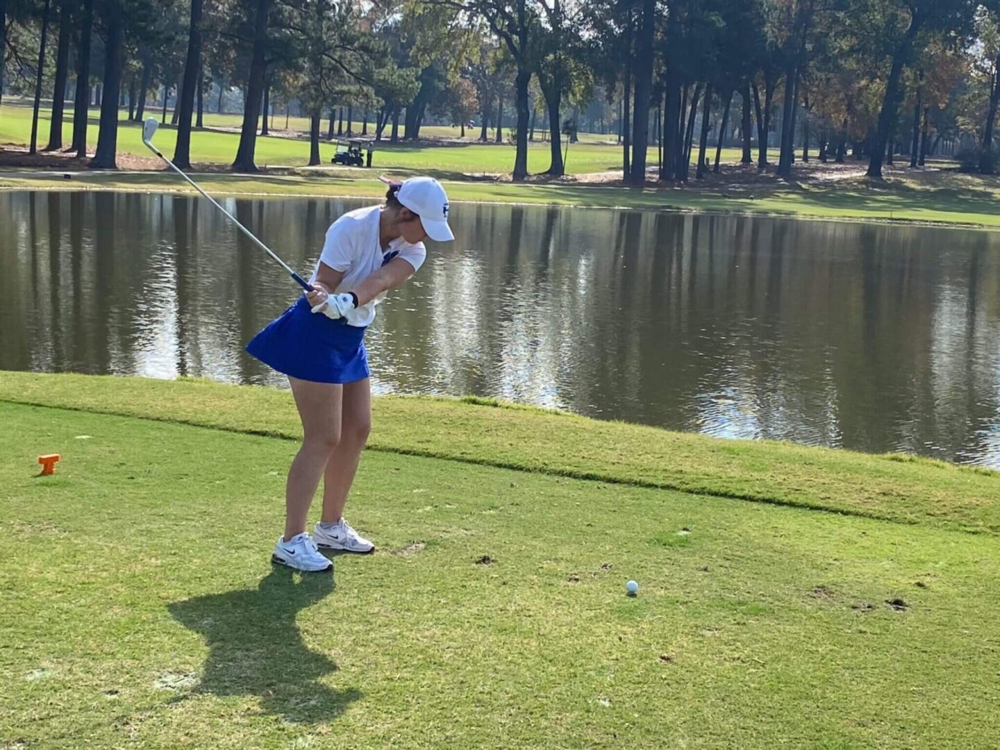Grace Holding a Club on a Golf Course
