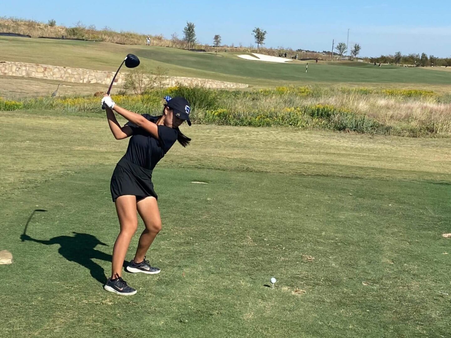 Morgan in a Black Top and Skirt Playing Golf